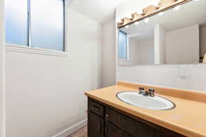 Bathroom featuring vanity, plenty of natural light, and light tile patterned flooring