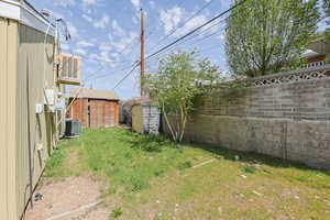 Fenced backyard with a storage shed