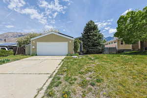Garage featuring a mountain view and driveway