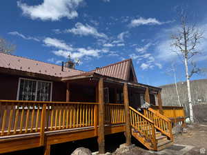 front view of cabin with a metal roof