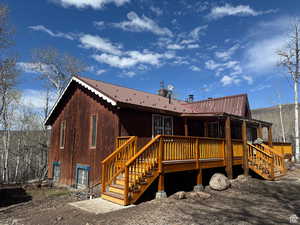 west side of property featuring a metal roof and a deck