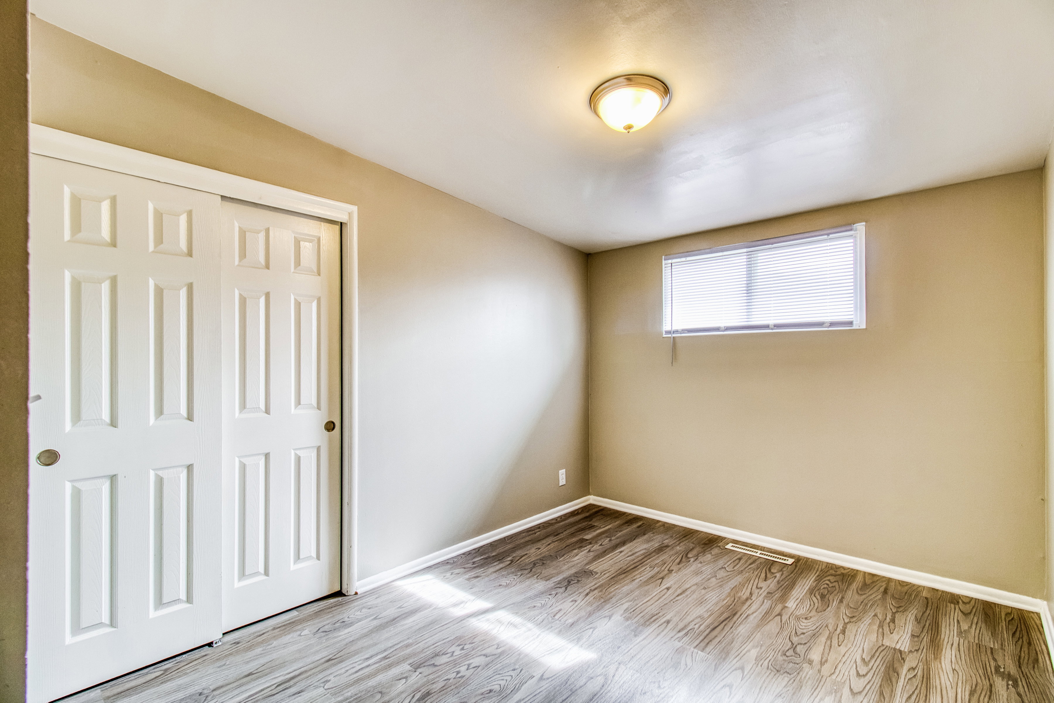 Unfurnished bedroom featuring light wood-type flooring and a closet