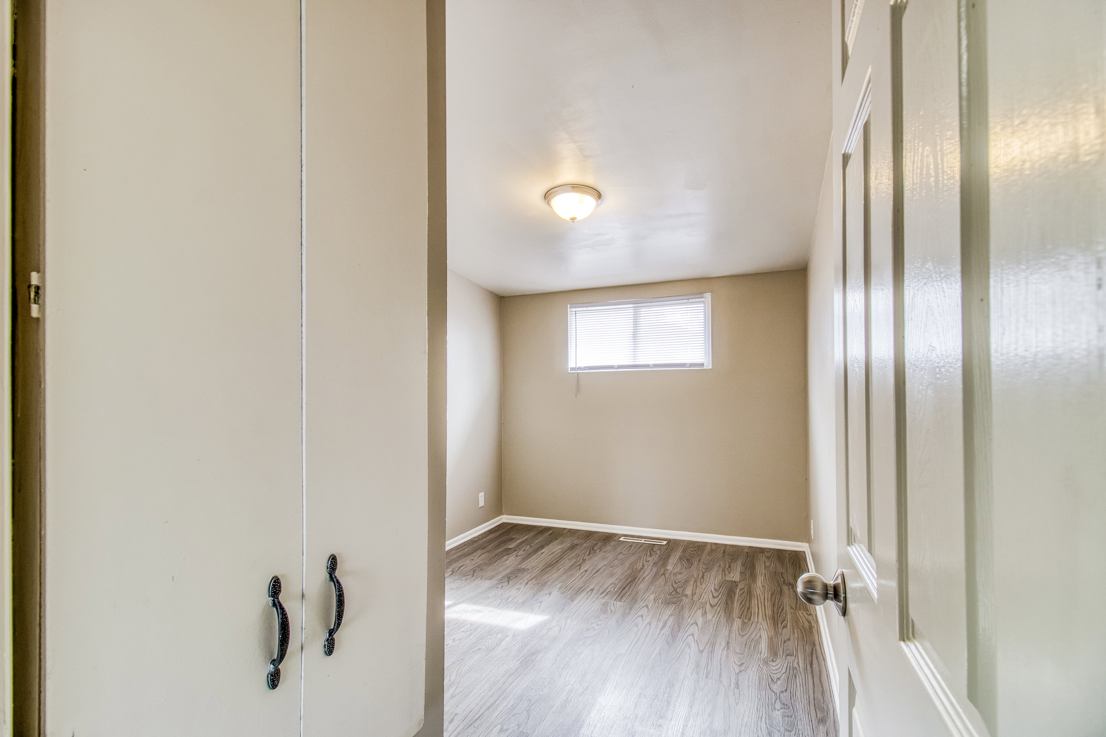 Spare room featuring light wood-style floors and baseboards