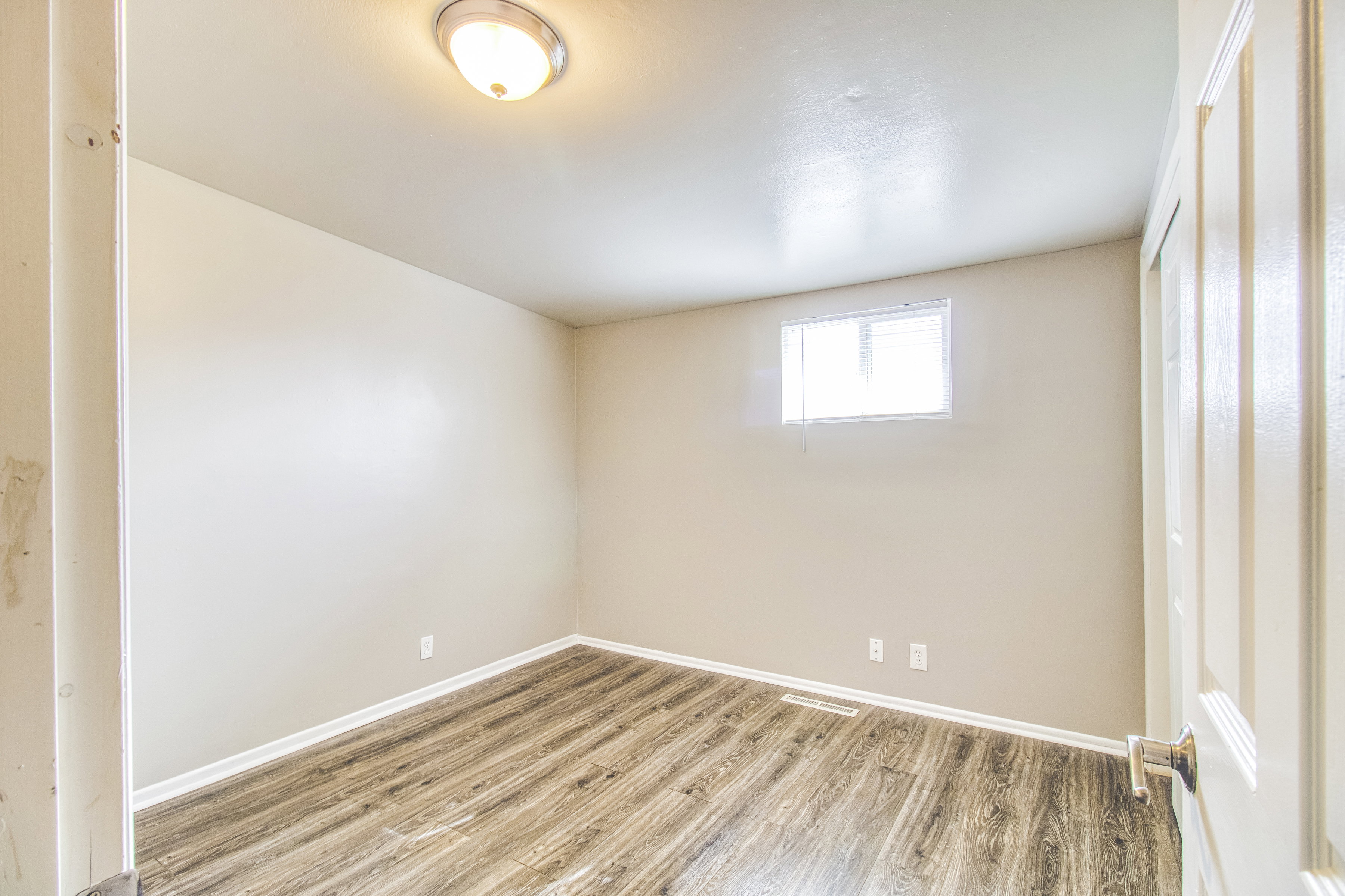 Empty room featuring light wood finished floors and baseboards