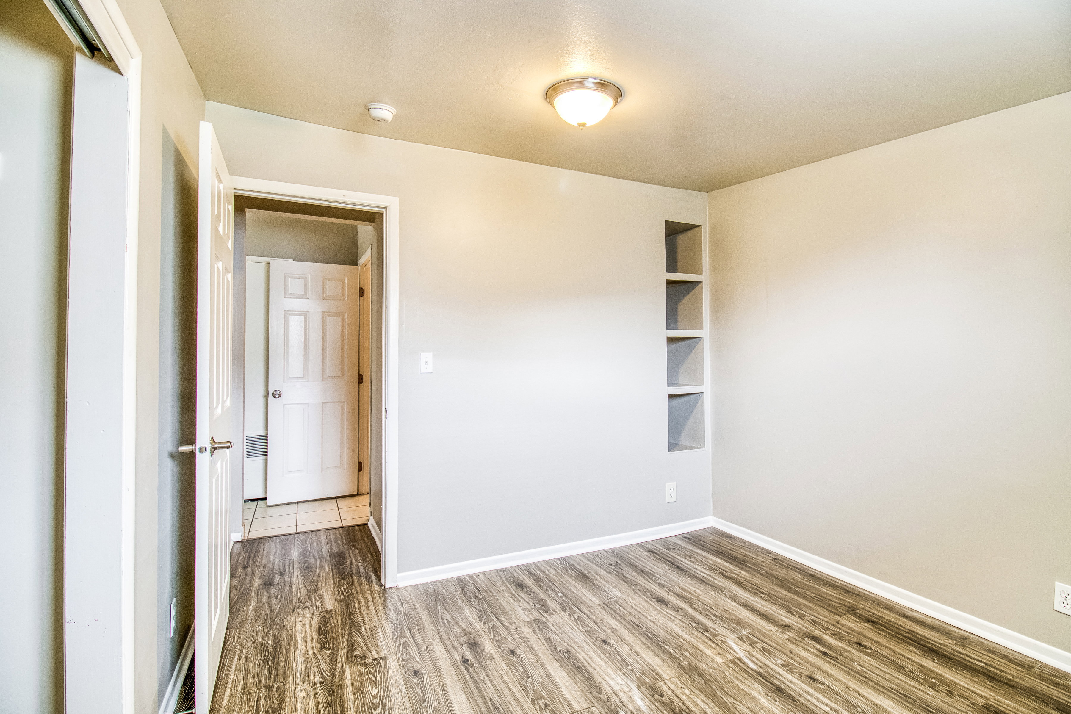 Empty room featuring light wood-type flooring and baseboards