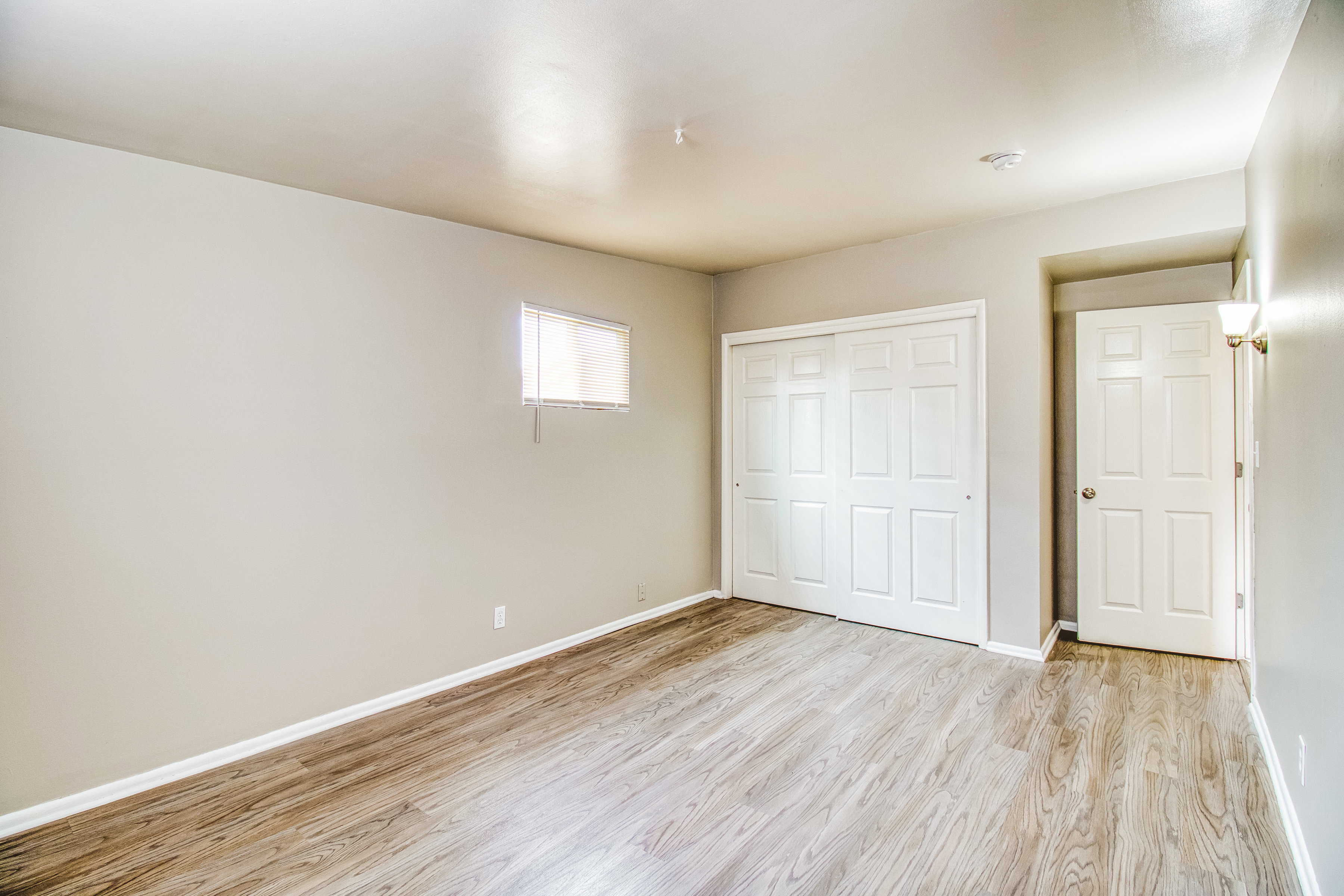 Unfurnished bedroom featuring light wood finished floors and a closet