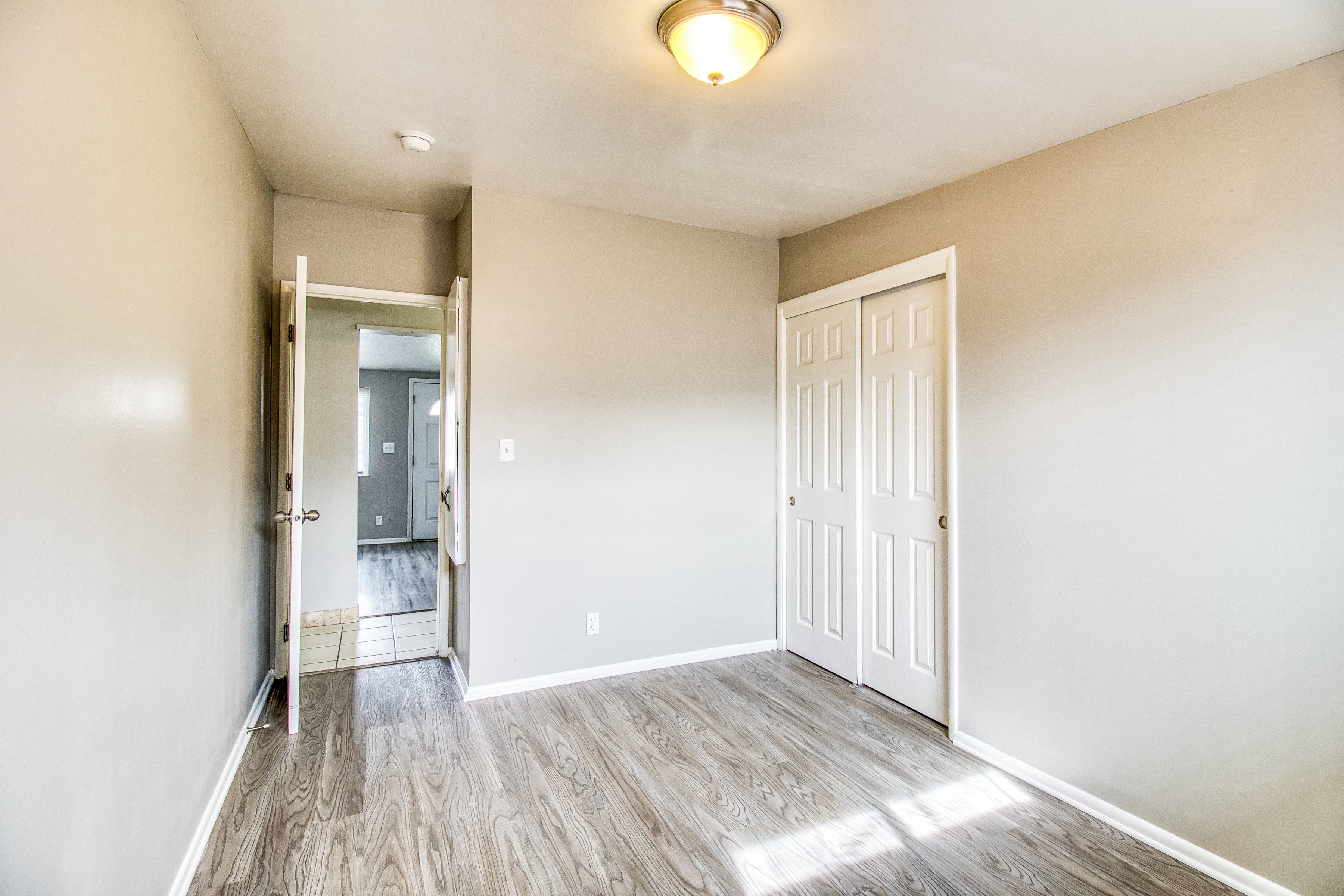 Unfurnished bedroom featuring light wood finished floors and a closet
