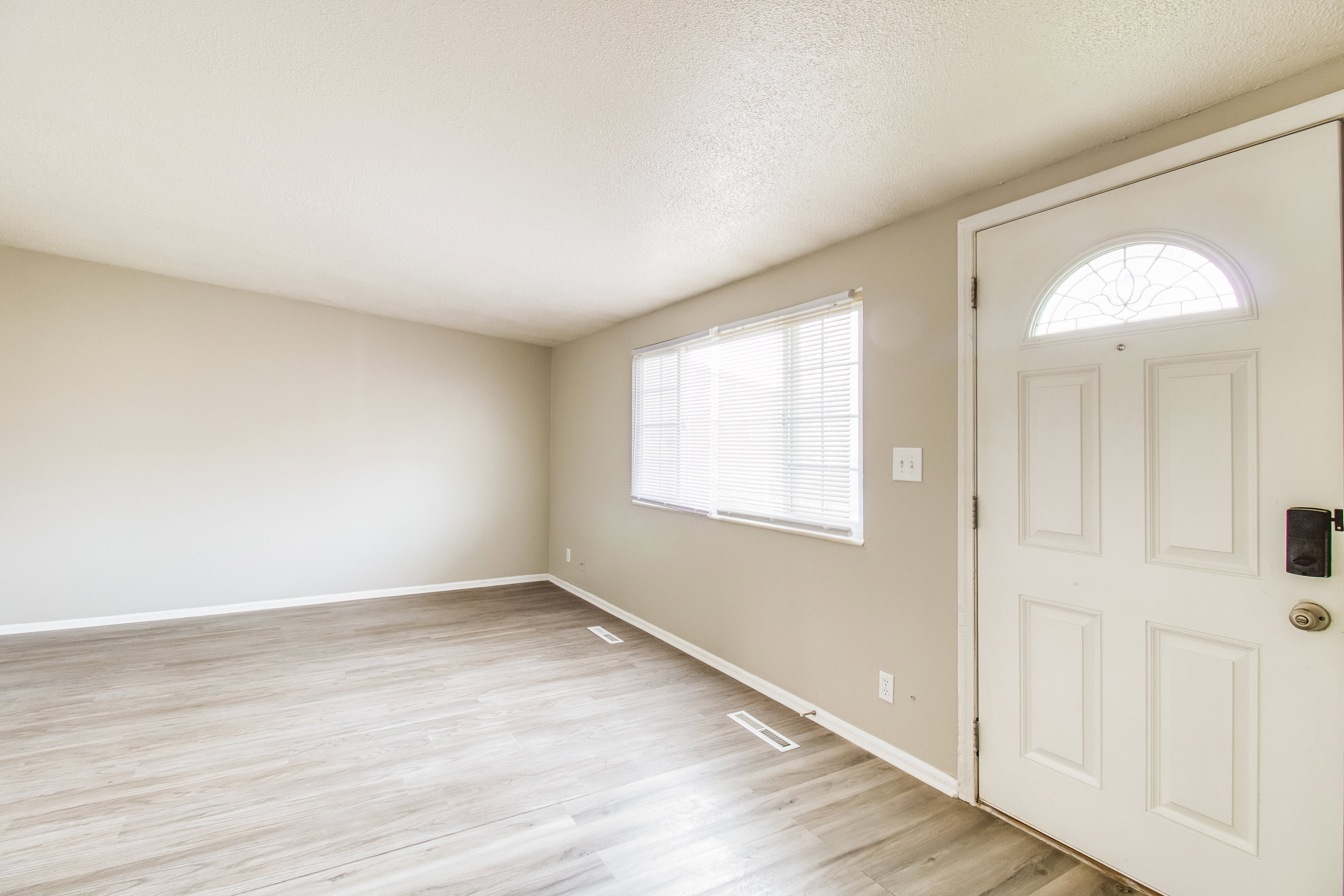 Entryway featuring light wood finished floors and a textured ceiling