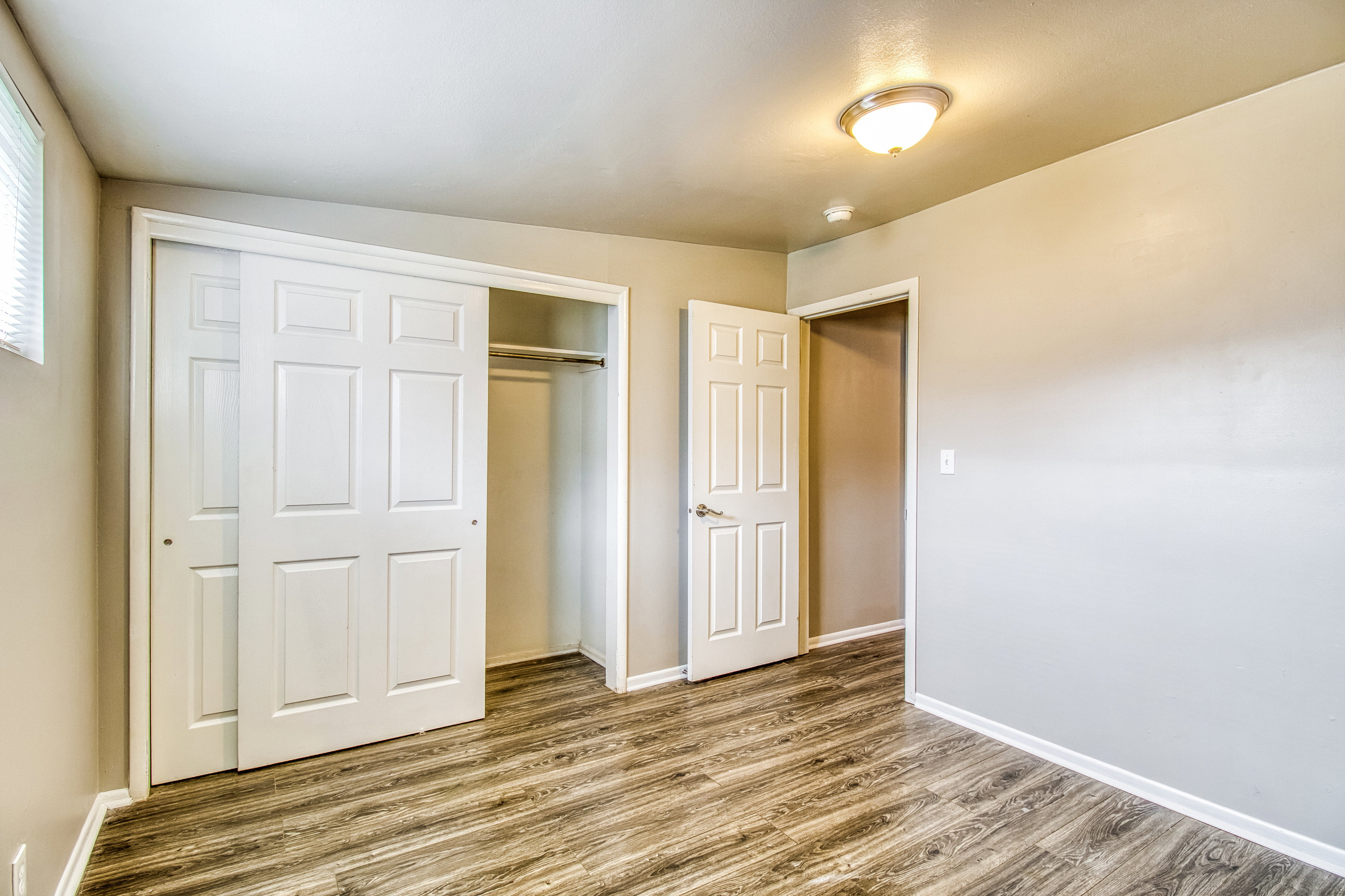 Unfurnished bedroom featuring wood finished floors and a closet