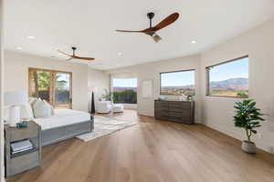 Bedroom with light wood-style flooring, multiple windows, access to exterior, ceiling fan, and recessed lighting