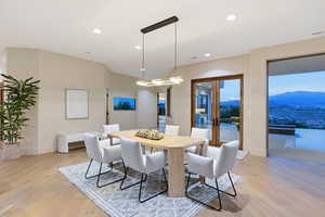 Dining area with light wood-style flooring, french doors, recessed lighting, and a mountain view