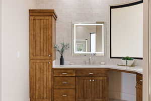 Bathroom featuring vanity and decorative backsplash