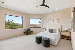 Carpeted bedroom with a ceiling fan and recessed lighting