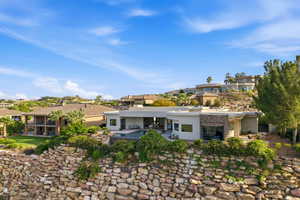 Rear view of property with stucco siding, a residential view, a chimney, and an outdoor pool
