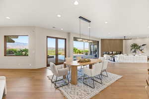 Dining space featuring french doors, light wood-style floors, and recessed lighting