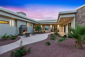 View of yard featuring a patio and a lit fireplace