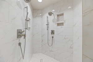 Bathroom featuring a marble finish shower
