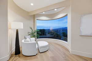 Living area featuring light wood finished floors and recessed lighting
