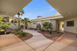 View of patio / terrace with a warm lit fireplace