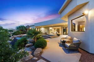View of patio / terrace with a pool with connected hot tub