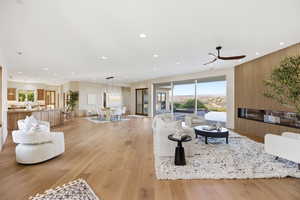Living area with light wood finished floors, recessed lighting, and a ceiling fan