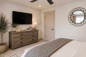 Master bedroom featuring ceiling fan, recessed lighting, and light colored carpet