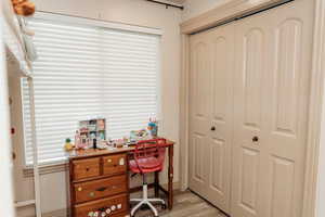 Bedroom with light wood finished floors and baseboards