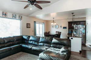 Living area featuring ceiling fan, lofted ceiling, and recessed lighting