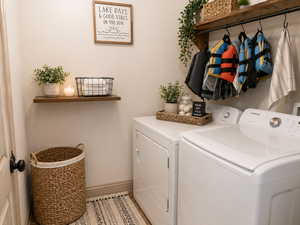Laundry room featuring independent washer and dryer and baseboards