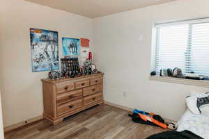 Bedroom featuring light wood finished floors and baseboards