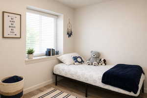 Bedroom with light wood-type flooring and baseboards