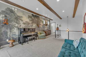Living area with carpet flooring, beam ceiling, and recessed lighting