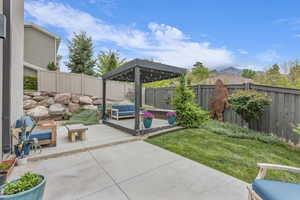 Fenced backyard featuring a patio, an outdoor lounge area, and a gazebo