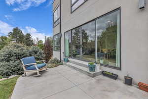 Entrance to property featuring stucco siding and a patio