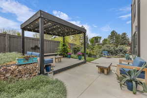 Fenced backyard featuring a pergola, an outdoor living space, a patio, and a wooden deck