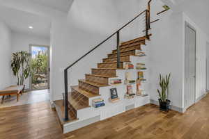 Staircase featuring wood-type flooring and recessed lighting