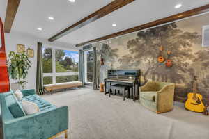 Carpeted living area featuring recessed lighting and beamed ceiling
