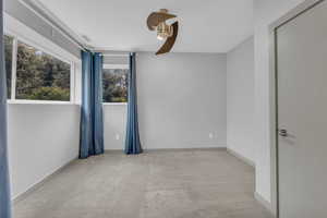 Empty room featuring light carpet and baseboards