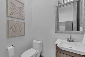 Half bath featuring vanity and toilet