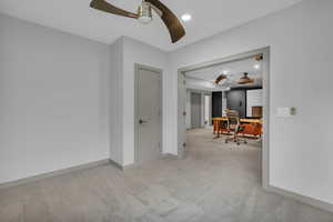 Unfurnished room with an office area, light carpet, recessed lighting, and ceiling fan