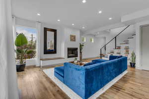 Living area featuring a fireplace, recessed lighting, light wood-style flooring, and plenty of natural light