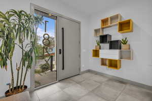 Foyer entrance featuring baseboards