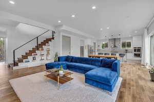 Living area with recessed lighting, healthy amount of natural light, and light wood-type flooring