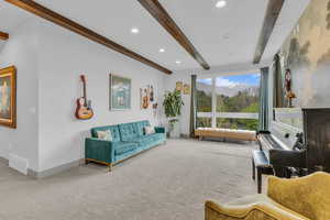 Carpeted living room featuring recessed lighting and beamed ceiling