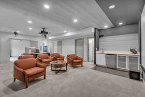 Living room featuring wet bar, recessed lighting, and light carpet