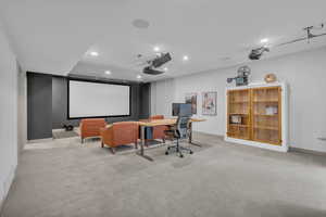 Home theater room with recessed lighting and light carpet