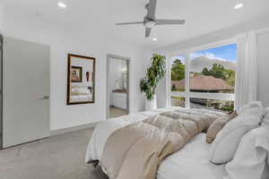 Bedroom featuring light carpet, ensuite bathroom, recessed lighting, and a ceiling fan