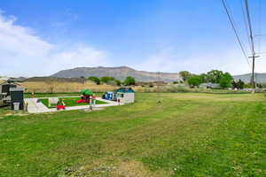 View of yard featuring a mountain view and an outbuilding