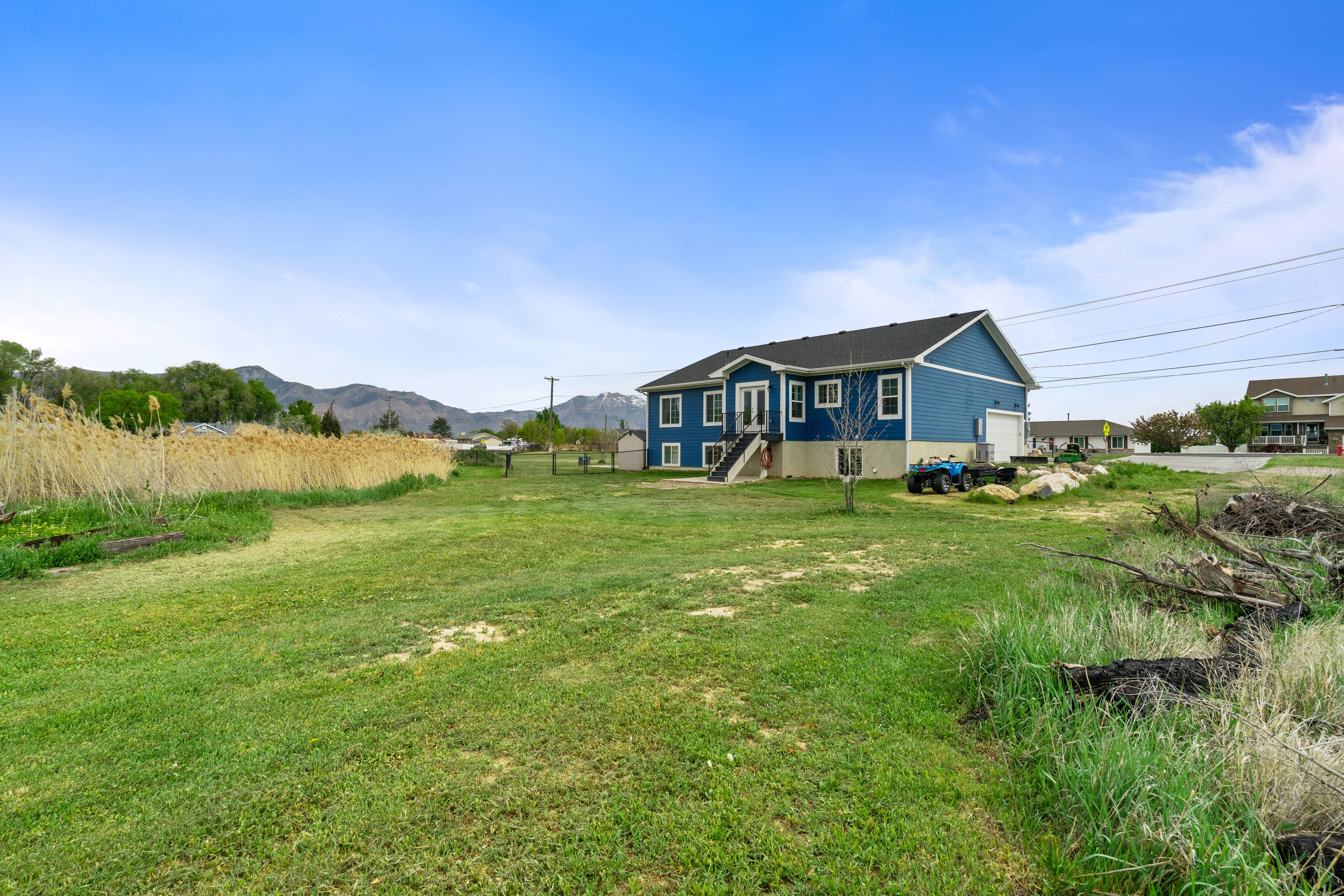 Rear view of house with a yard and a mountain view