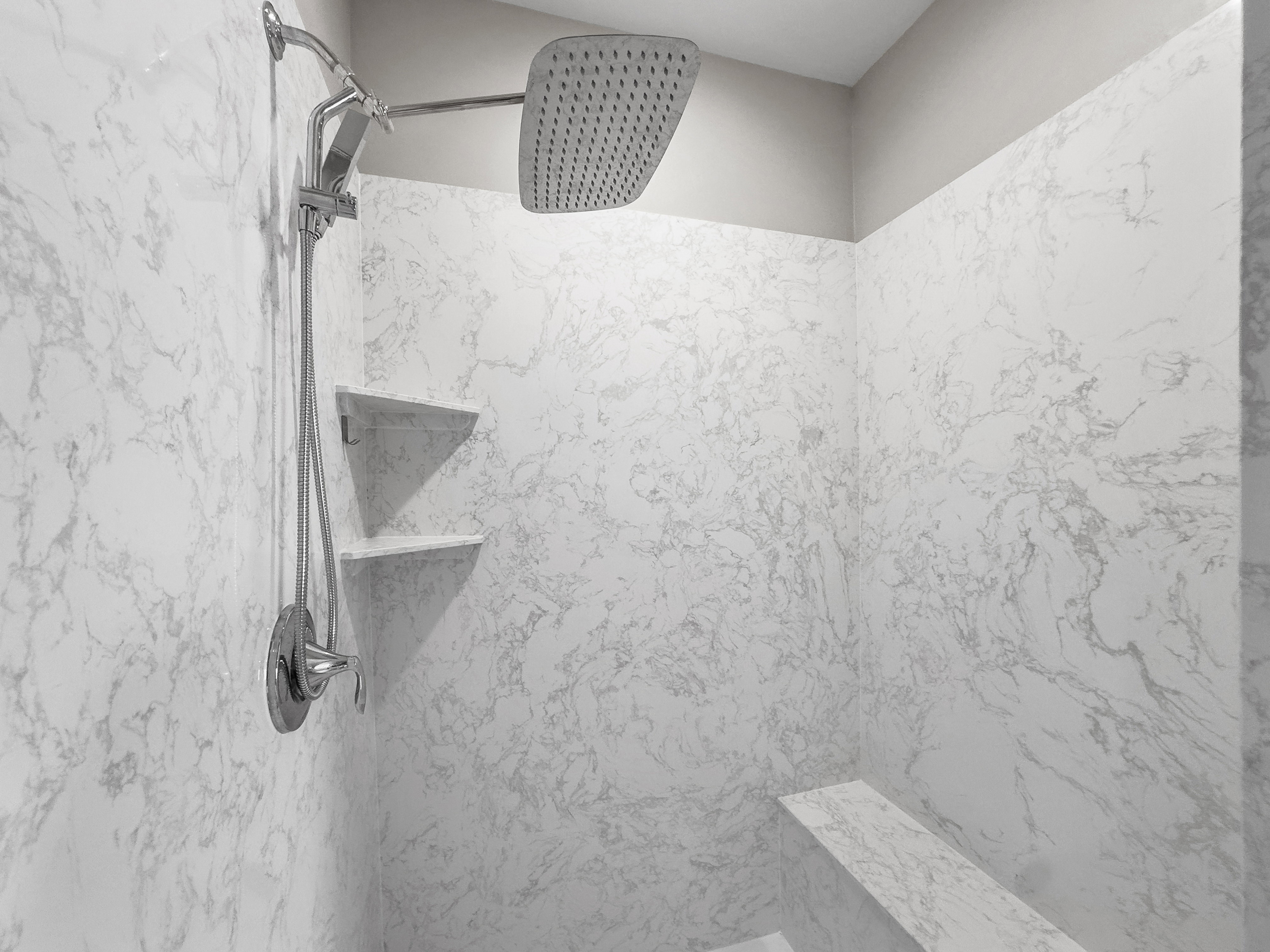 Bathroom view of a marble finish shower